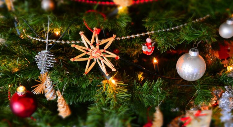 Close-up of a decorated Christmas tree with lights and ornaments, showcasing holiday spirit.